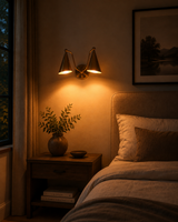 Aurelia double cone wall sconce by Brass Leaf Studio shown in a warm interior with two tapered shades and soft downward lighting
