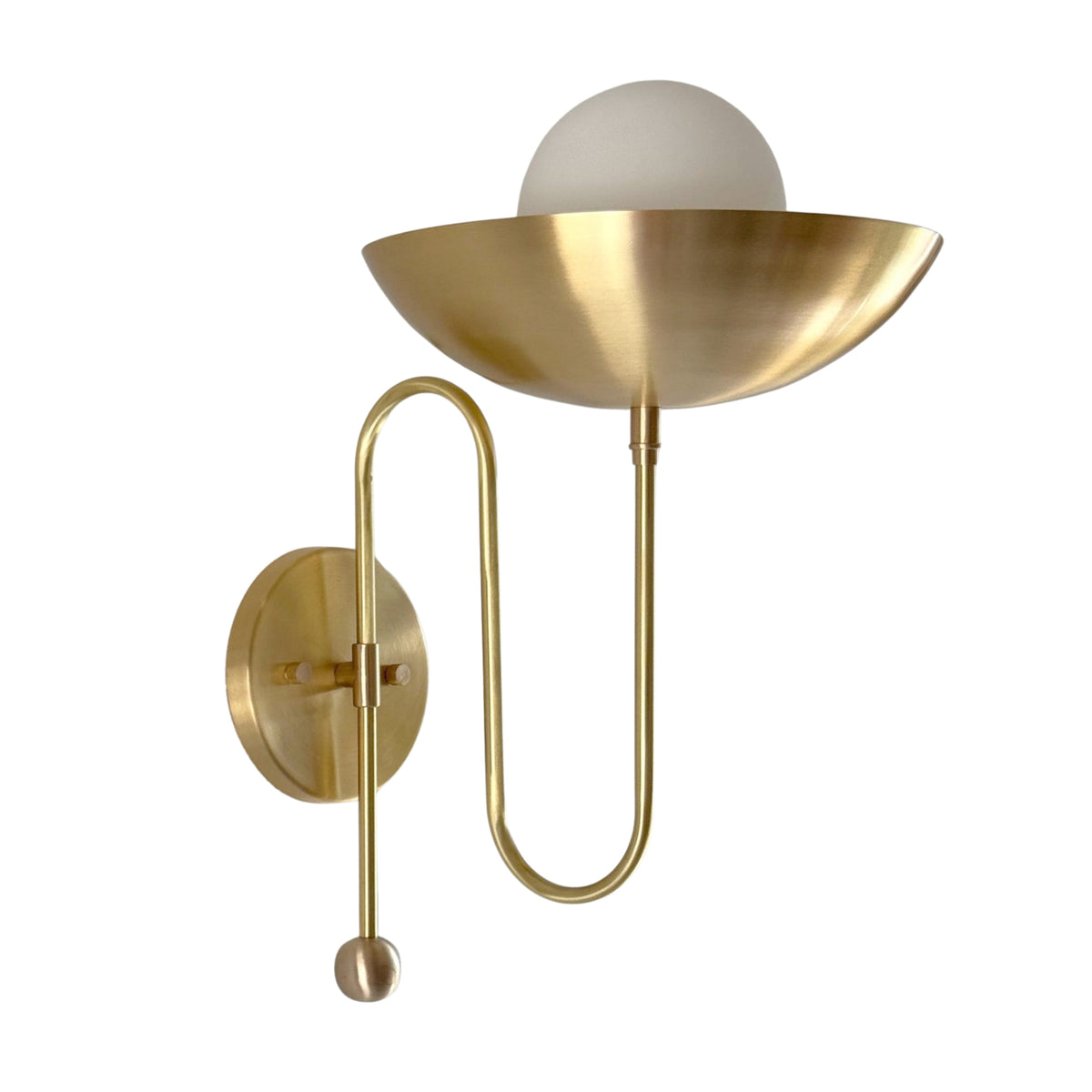 Close-up view of the Aurora brass bowl wall sconce featuring the handcrafted bowl shade, frosted globe diffuser, and refined brass detailing.