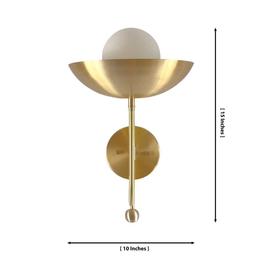 Aurora modern brass bowl wall sconce installed in a contemporary living room, providing warm ambient lighting above a wooden console table.