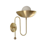 Front angled view of the Aurora brass bowl wall sconce showcasing the minimalist bowl shade, frosted globe, and decorative loop arm design.