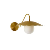 Angled view of the Aurora brass flower shade wall sconce showcasing the sculptural fluted shade, frosted globe, and curved brass arm.