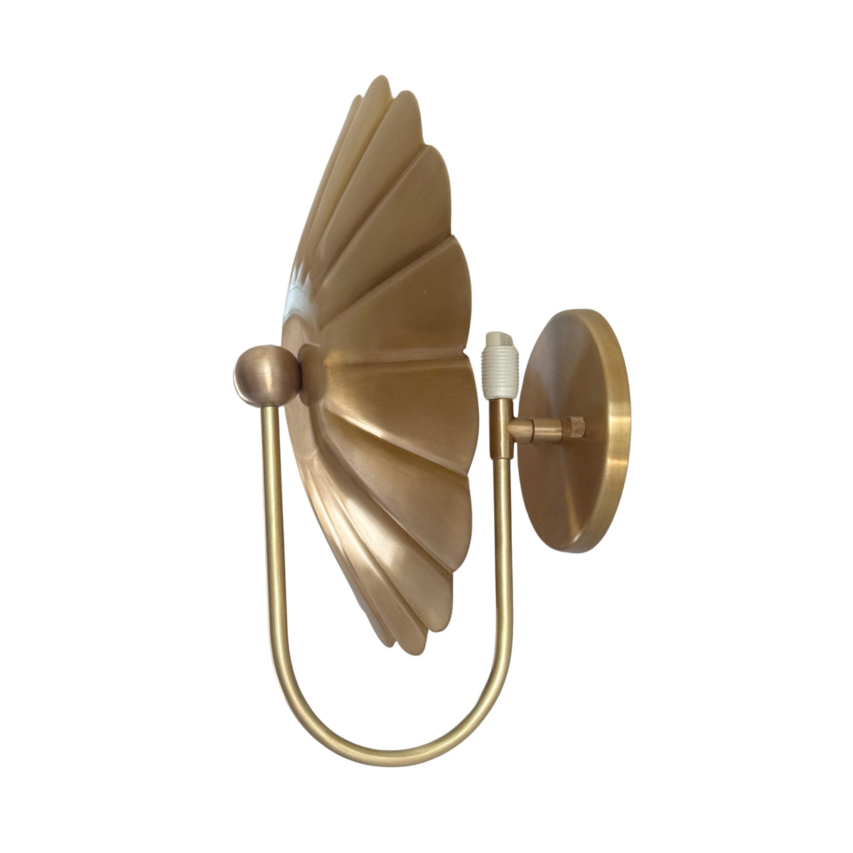 Side profile of the Aurora floral brass wall sconce highlighting the sculptural depth, curved arm, and wall mounting design.