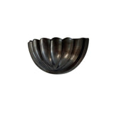 Angled view of the Aurora modern gunmetal fluted half bowl wall sconce showcasing its sculptural ribbed profile and contemporary design.