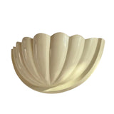 Front perspective of the Aurora modern ivory fluted half bowl wall sconce featuring a sculptural ribbed design and soft ivory finish.
