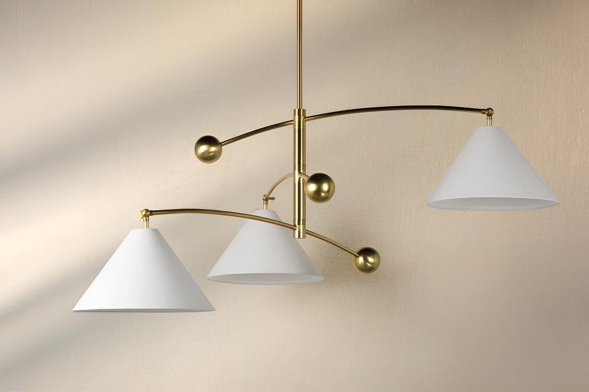 Handmade balance brass 3 light chandelier casting soft ambient glow in a refined modern space
