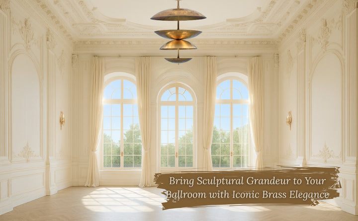 Sculptural brass chandelier in an elegant ballroom with large arched windows and ornate molding.