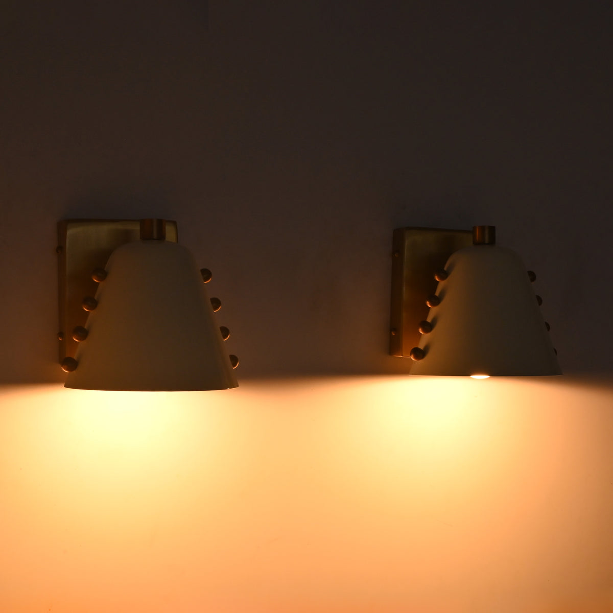 Set of two wall sconces above bathroom vanity mirror with warm light for refined bathroom décor