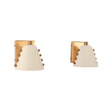 Bedside wall sconce pair creating warm reading light and balanced decorative lighting on both sides of the bed