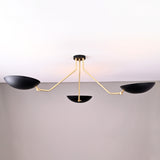 Front view of modern black and brass 3-light bowl chandelier with sculptural arms and matte black shades.