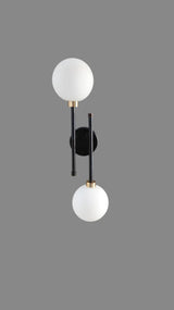 Product shot of handcrafted black and brass double globe wall light by Brass Leaf Studio showcasing elegant symmetry.