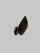 Modern black brass leaf-shaped wall sconce for bedrooms and living spaces