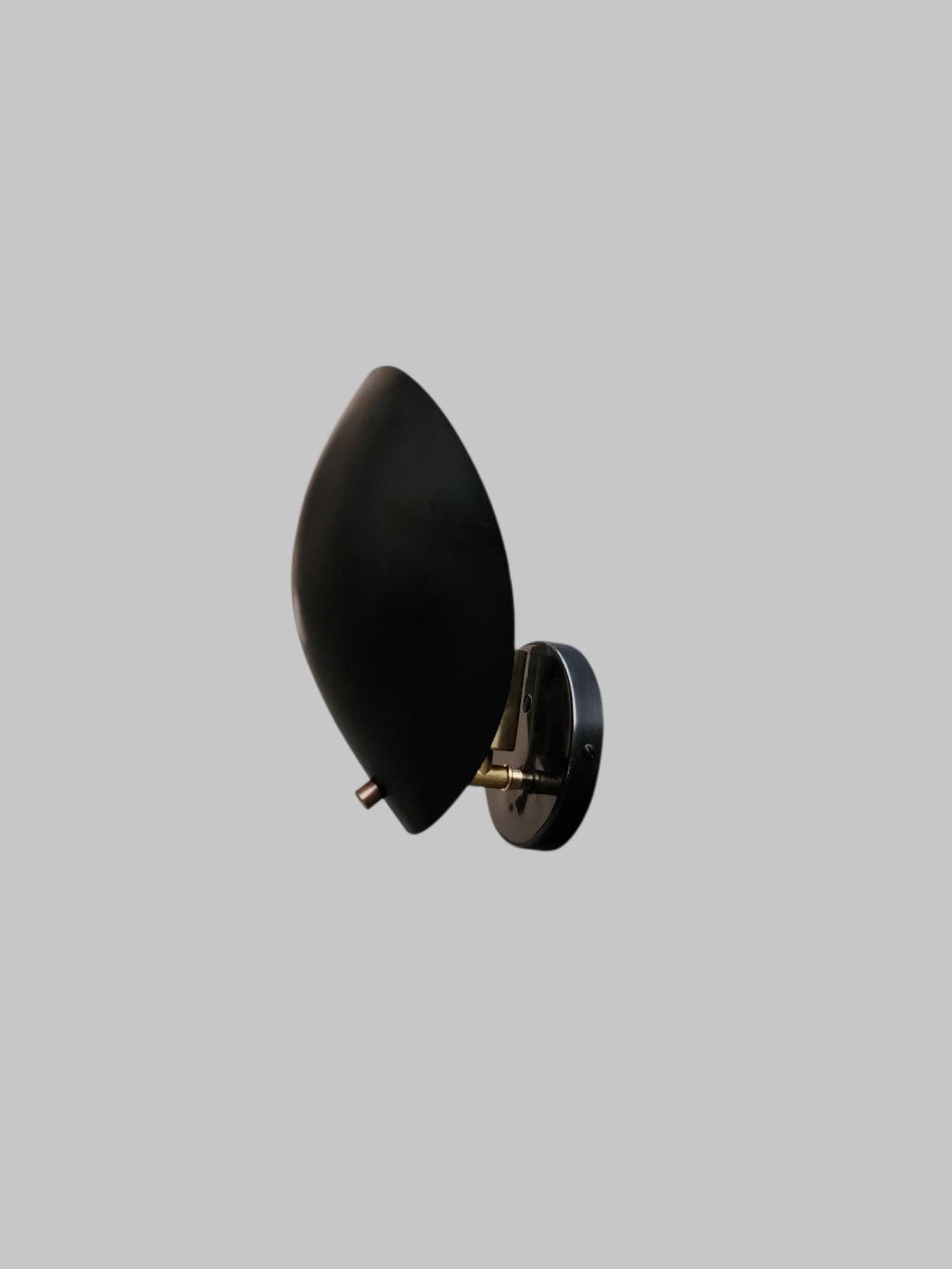 Side view of black brass leaf-shaped wall sconce by Brass Leaf Studio