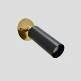 Adjustable black and brass spotlight wall light with cylindrical design for modern interiors