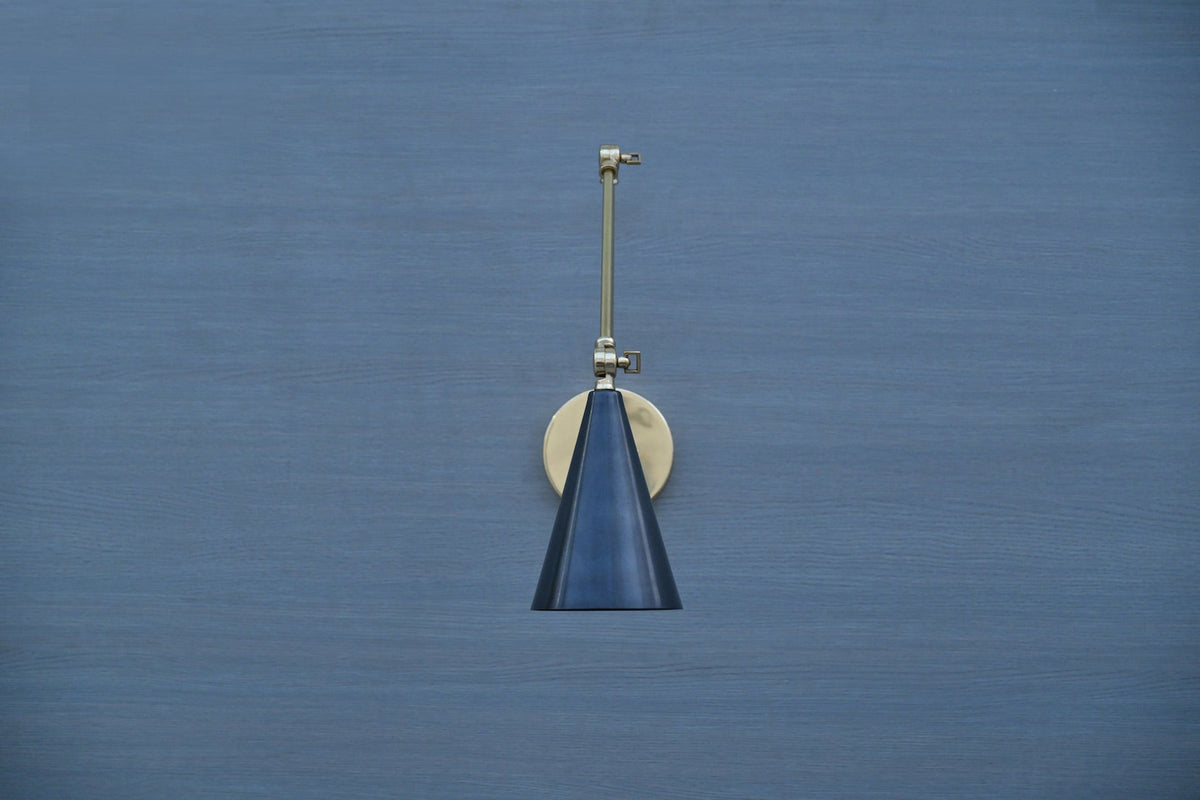 Brass wall-mounted light with black cone shade and adjustable arm