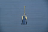 Brass wall-mounted light with black cone shade and adjustable arm
