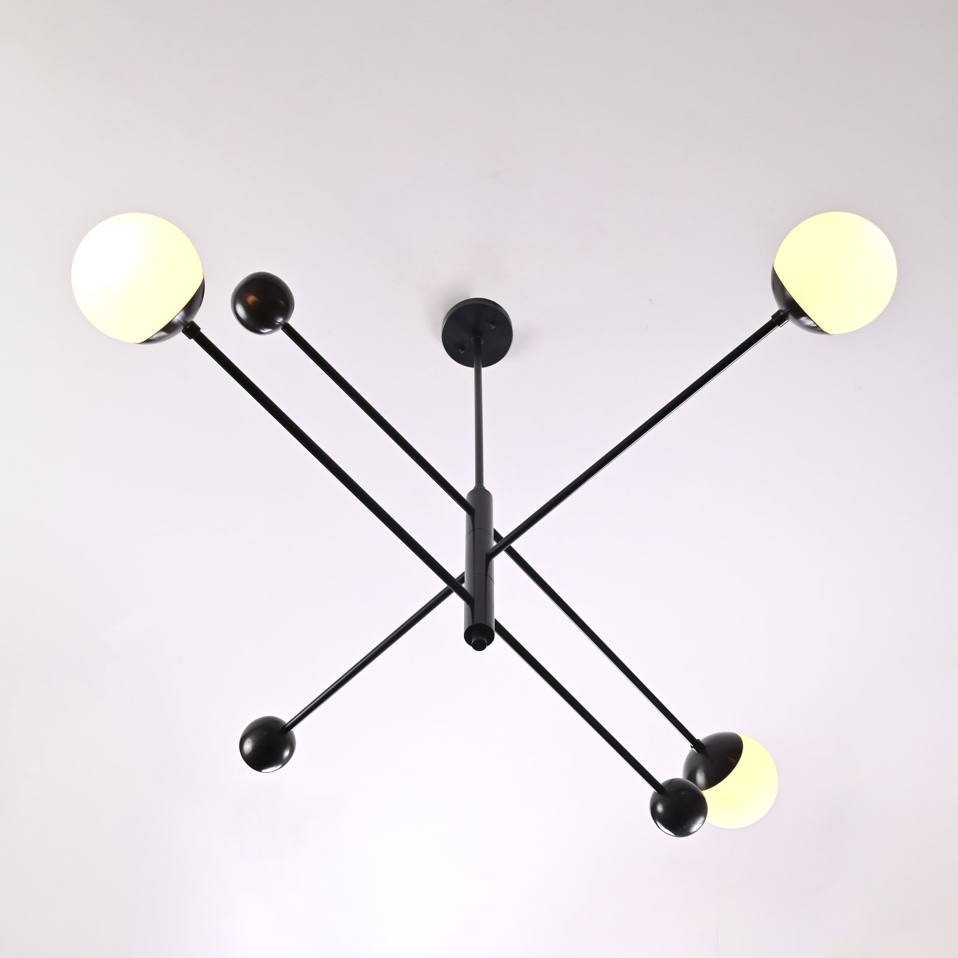 Top view of modern black globe chandelier with geometric minimalist arms