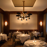 Black and white enamel brass chandelier shown lit with warm glow, curved accent shades, and downward cone lighting
