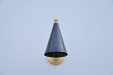 Front view of blackened brass cone wall light showing minimalist tapered shade and golden brass fixture.