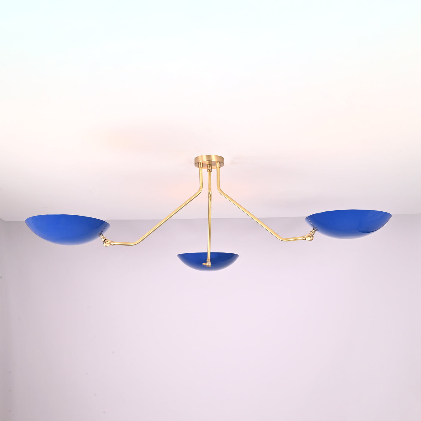 Modern three-light flush mount ceiling light with blue bowl shades and brushed brass arms by Brass Leaf Studio