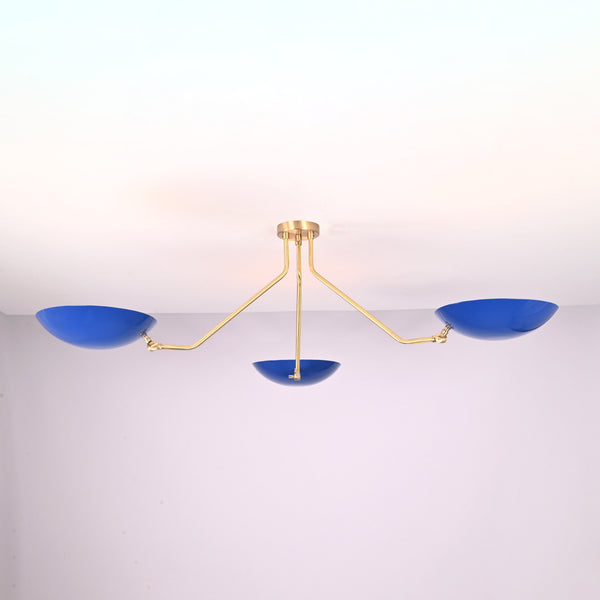 Modern three-light flush mount ceiling light with blue bowl shades and brushed brass arms by Brass Leaf Studio