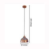 Blue copper dome pendant lamp installed above a dining table with warm downward glow and rustic modern style