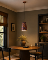 Blue copper patina pendant light installed above a kitchen island with warm focused lighting and artistic texture