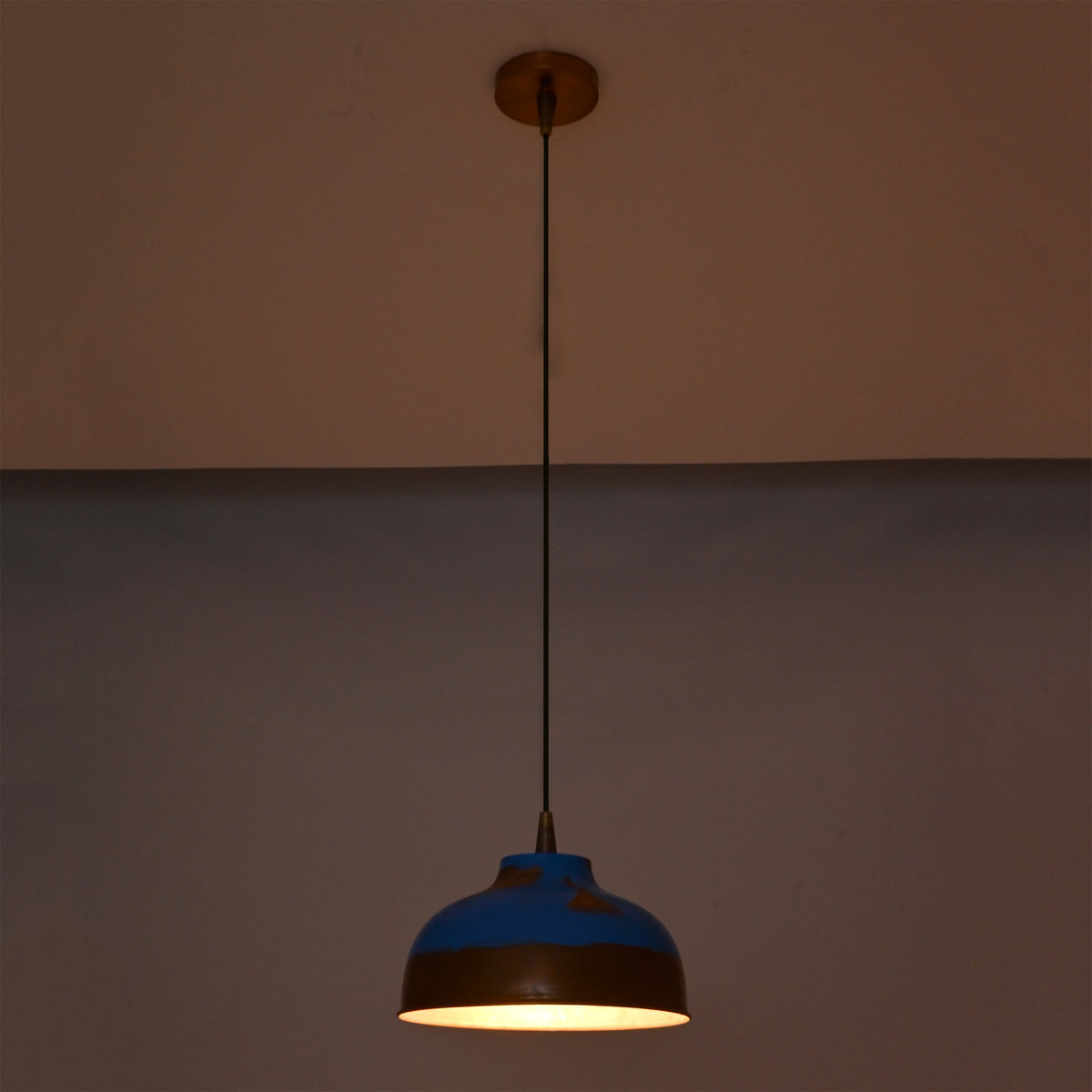 Blue and copper dome pendant lights installed in a hallway, adding warm glow and decorative ceiling lighting