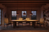 Blue copper pendant light hanging in a dining room with exposed copper detail and warm focused illumination