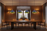 Blue green copper pendant light hanging above a dining table with warm glow and rustic modern style