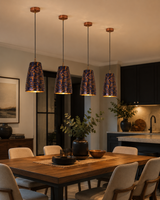 Blue patina ribbed pendant light hanging above a dining table with warm downward glow for cozy home interiors