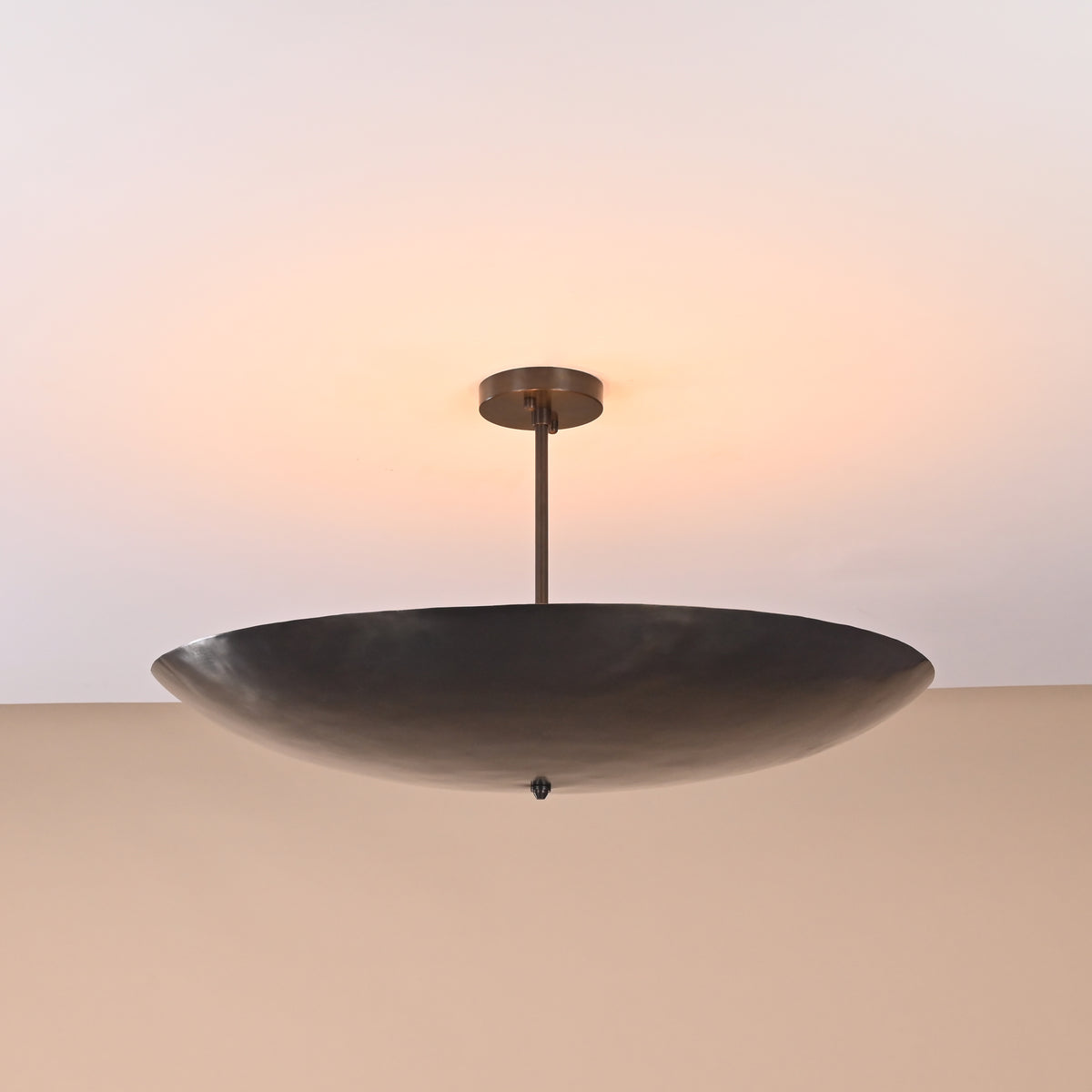 5-light brass ceiling fixture glowing in dark room with soft ambient lighting