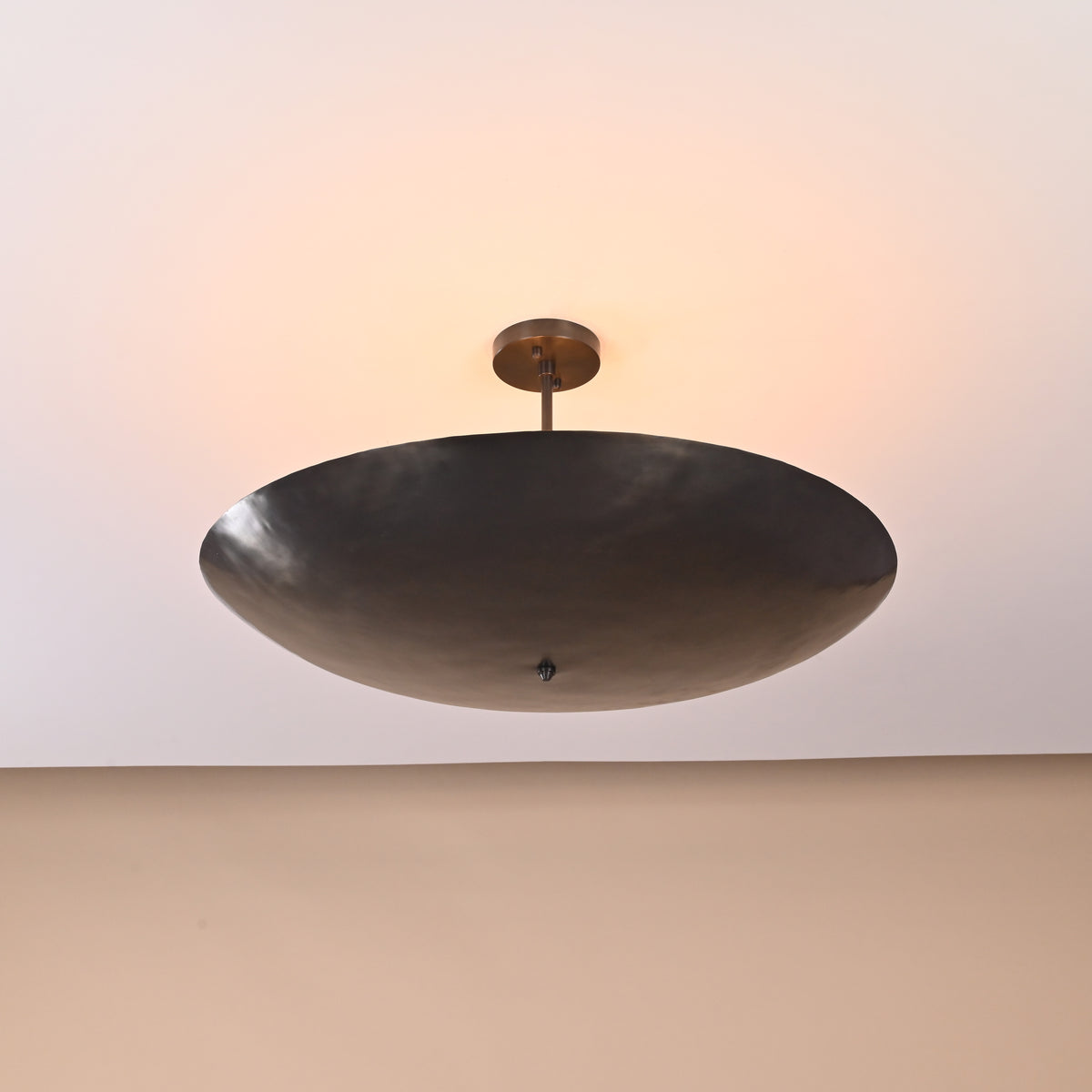 Illuminated bowl brass ceiling light showing warm indirect lighting effect