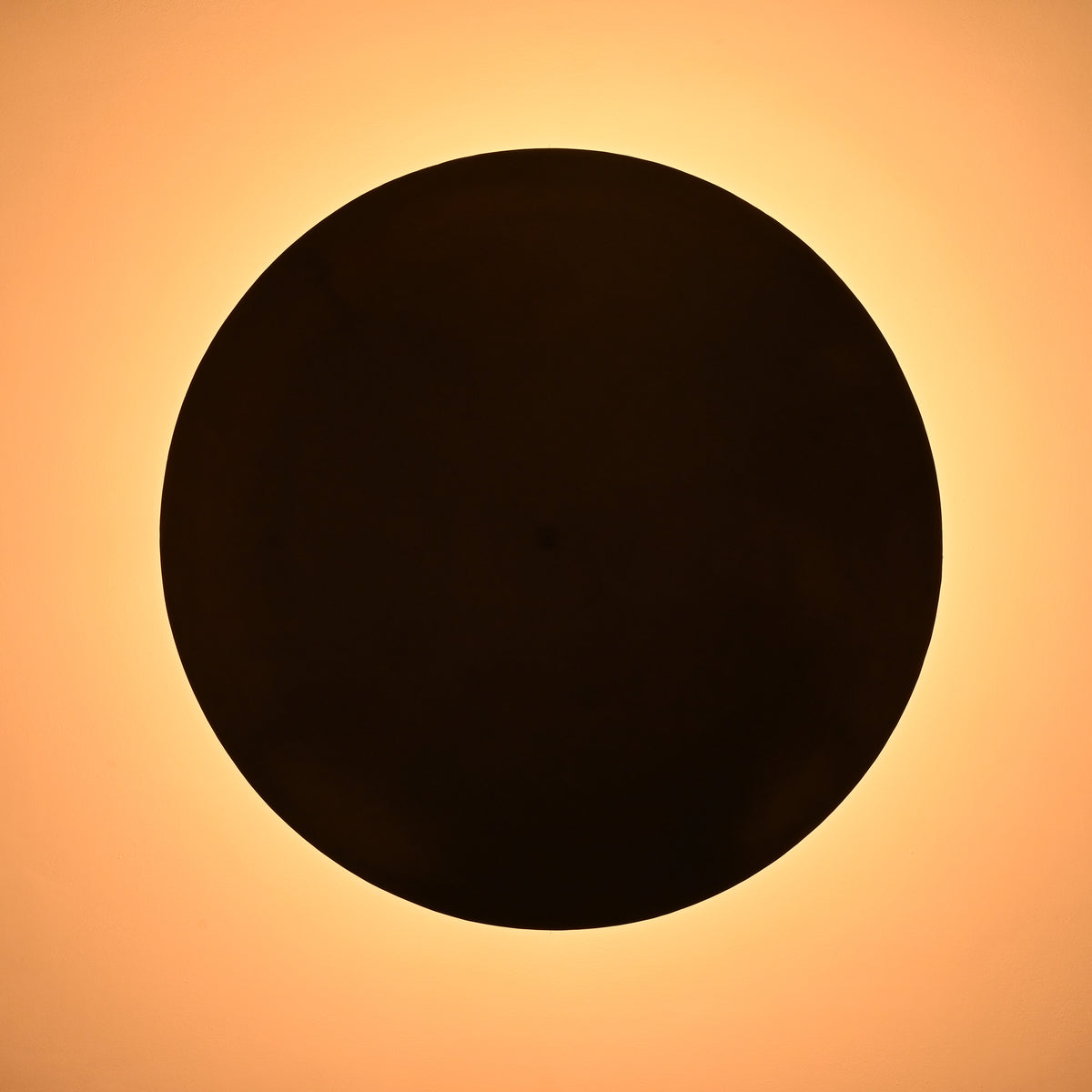 Overhead view of bowl-shaped brass ceiling light with warm ambient glow
