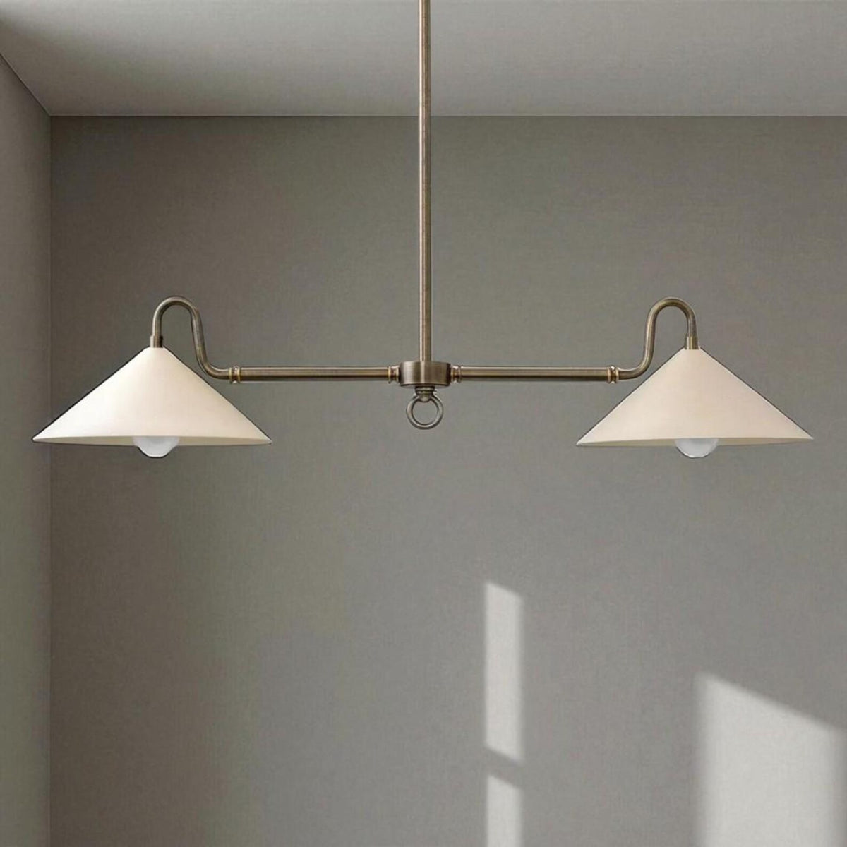 Solid brass 2-light cone chandelier illuminating a dining table with warm indirect lighting