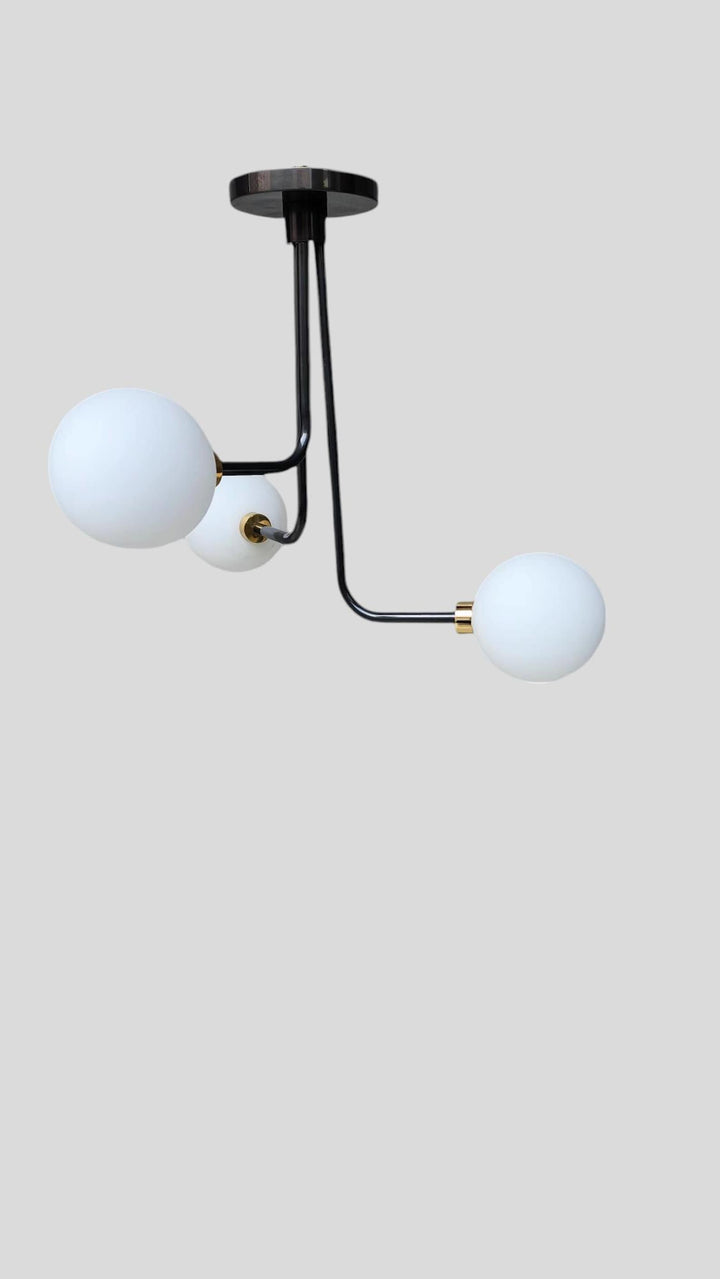 Minimalist brass ceiling chandelier with three globe shades – alternate view