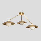 Handmade brass 3-light flushmount chandelier with wide bowl-shaped shades and white globes, modern industrial design view from side angle.