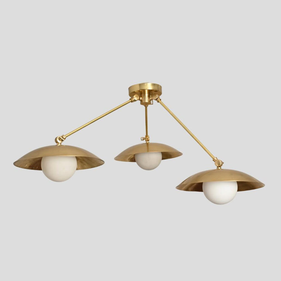 Handmade brass 3-light flushmount chandelier with wide bowl-shaped shades and white globes, modern industrial design view from side angle.
