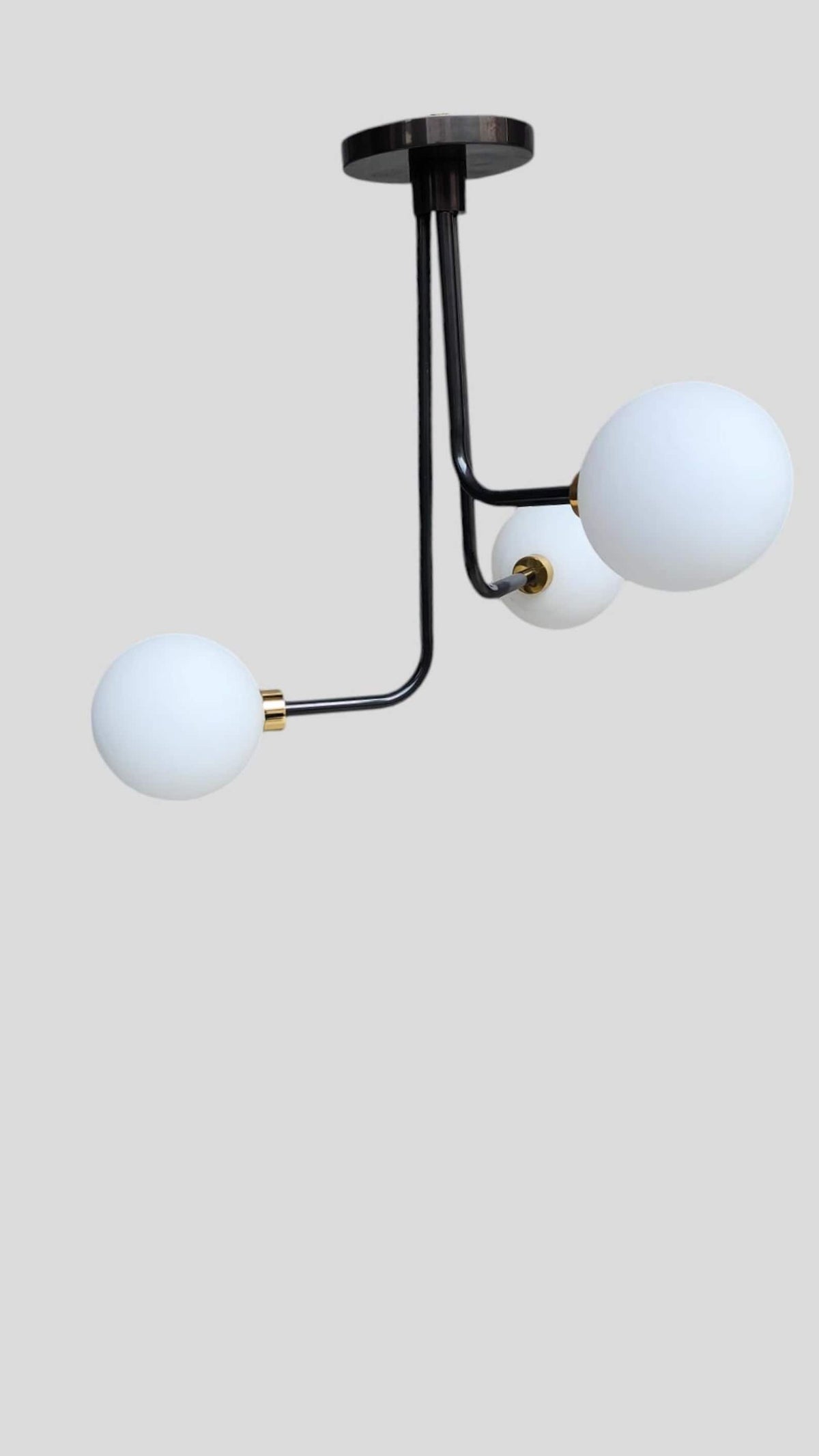 Contemporary brass flushmount chandelier with three globe lights – upward perspective