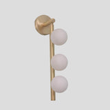 Handmade brass wall lamp with three frosted glass globes, customizable modern vertical sconce design
