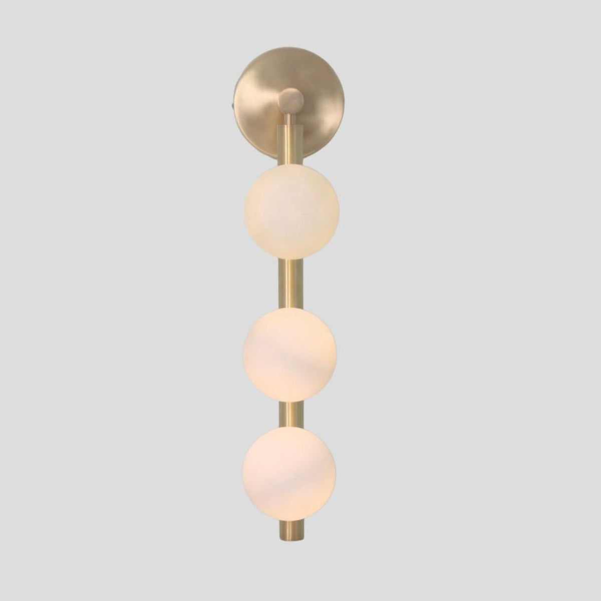 Modern handmade brass wall light with three frosted glass globe shades, vertical sconce straight-on view