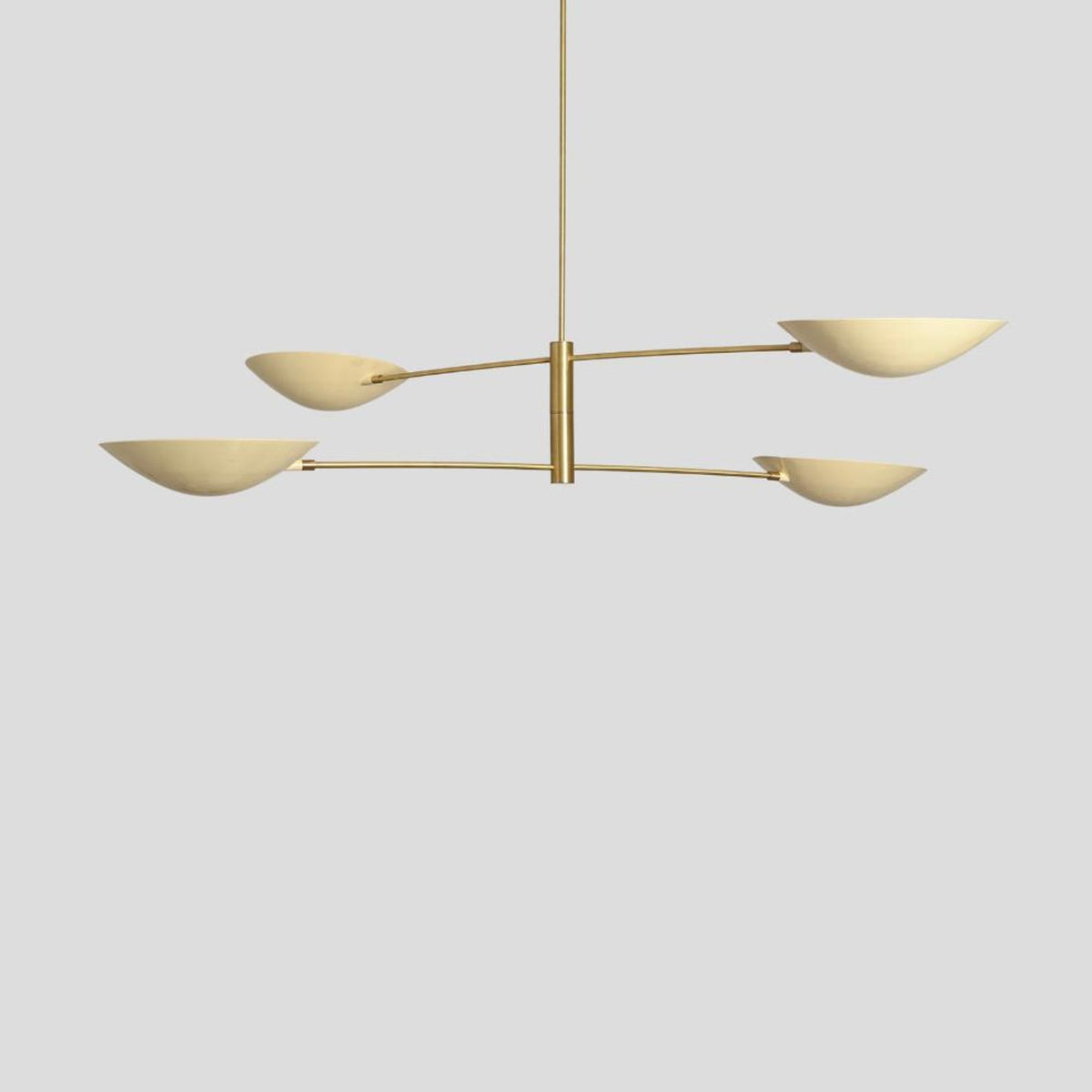 Contemporary brass chandelier with four elegant bowl shades, minimalist handmade design – side angle view.