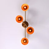 Overhead view of four-light brass bowl shade chandelier spreading ambient warm light, handcrafted flushmount fixture.
