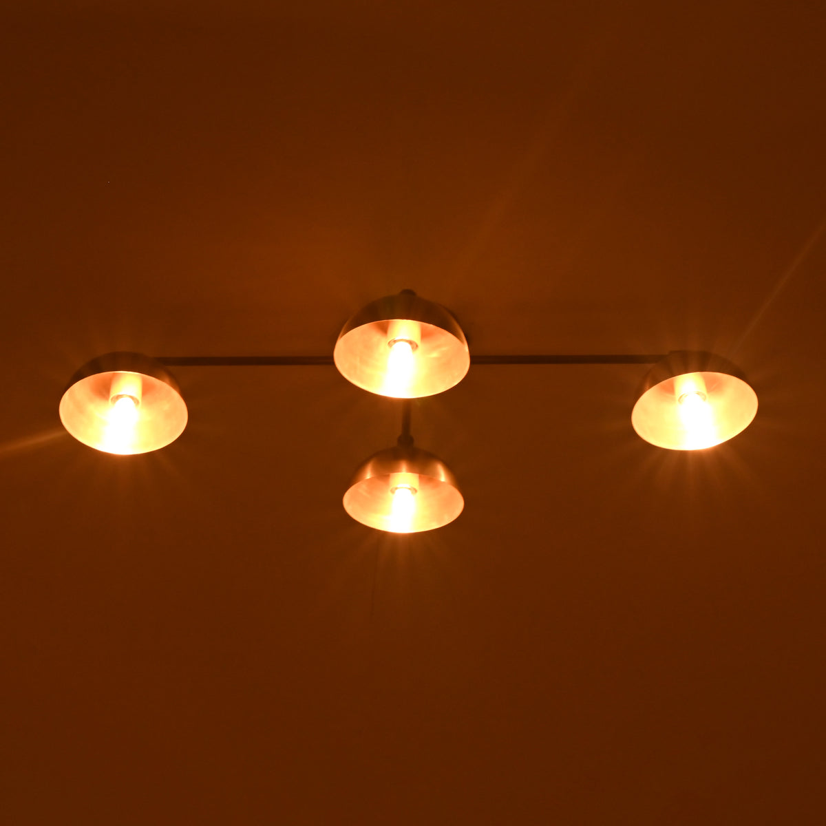 Brass mid-century style 4-light flushmount chandelier with warm ambient lighting and elegant brushed brass shades.