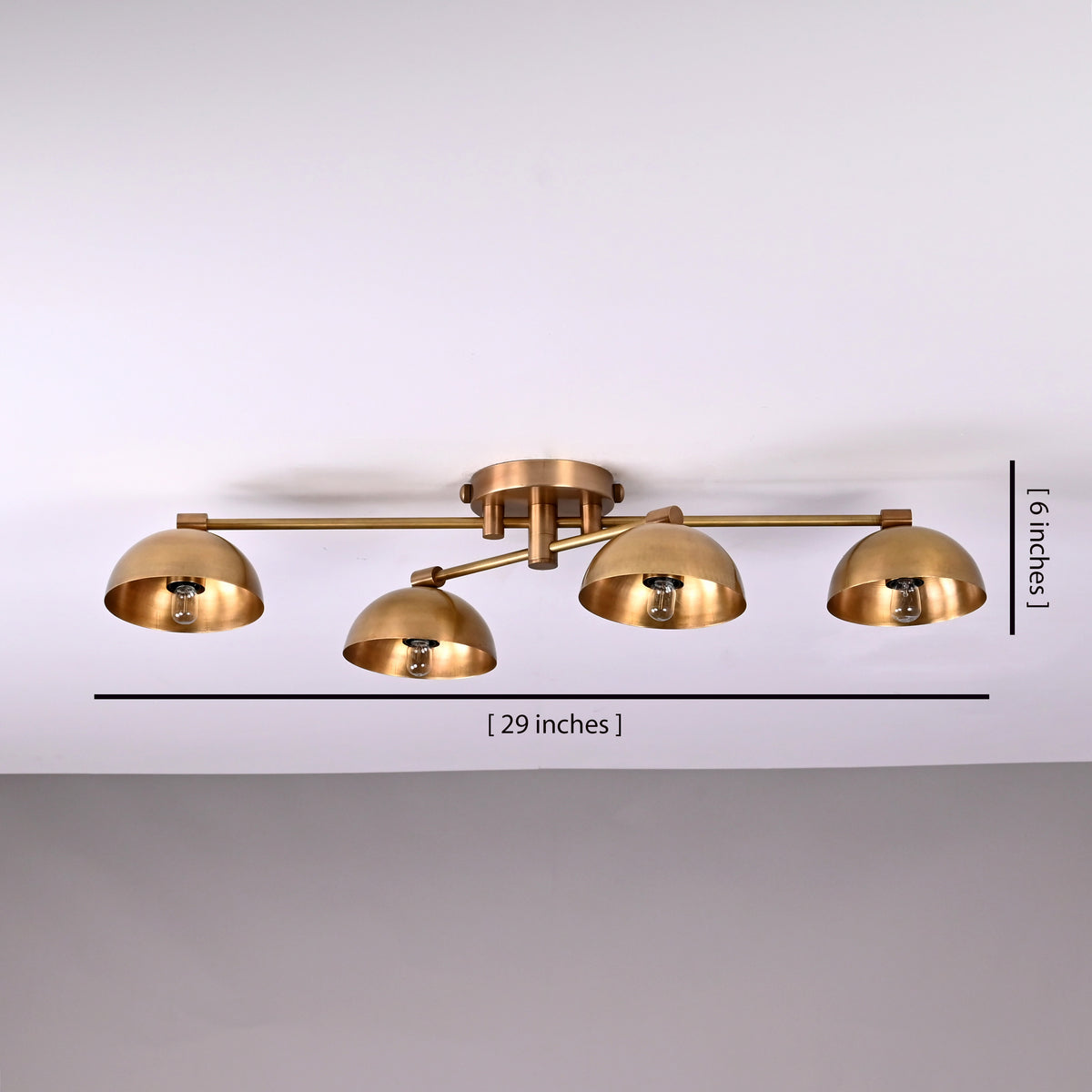 Modern brass 4-light bowl shade flushmount chandelier with adjustable arms in brushed brass finish, 29-inch wide ceiling light.
