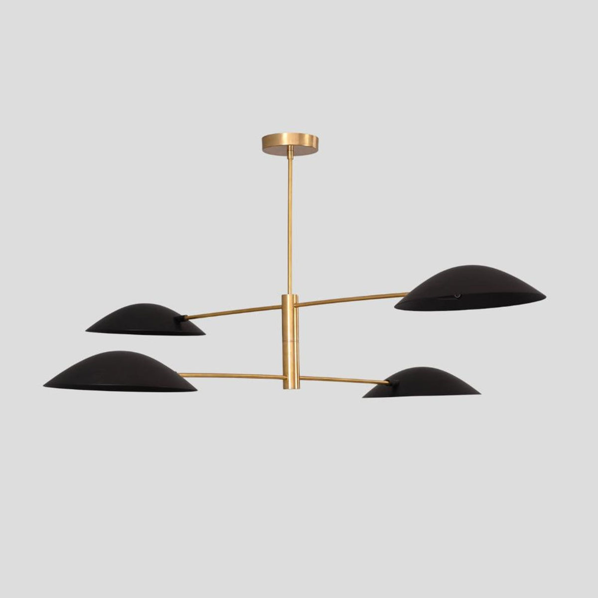Brass pendant chandelier with four matte black sculpted bowl shades, minimalist statement piece for stylish modern homes.