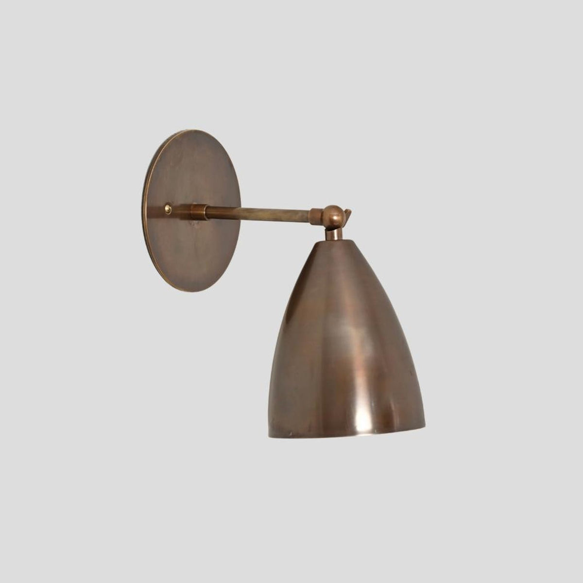 Minimalist brass wall light with cone-shaped shade and adjustable arm – handmade by Brass Leaf Studio