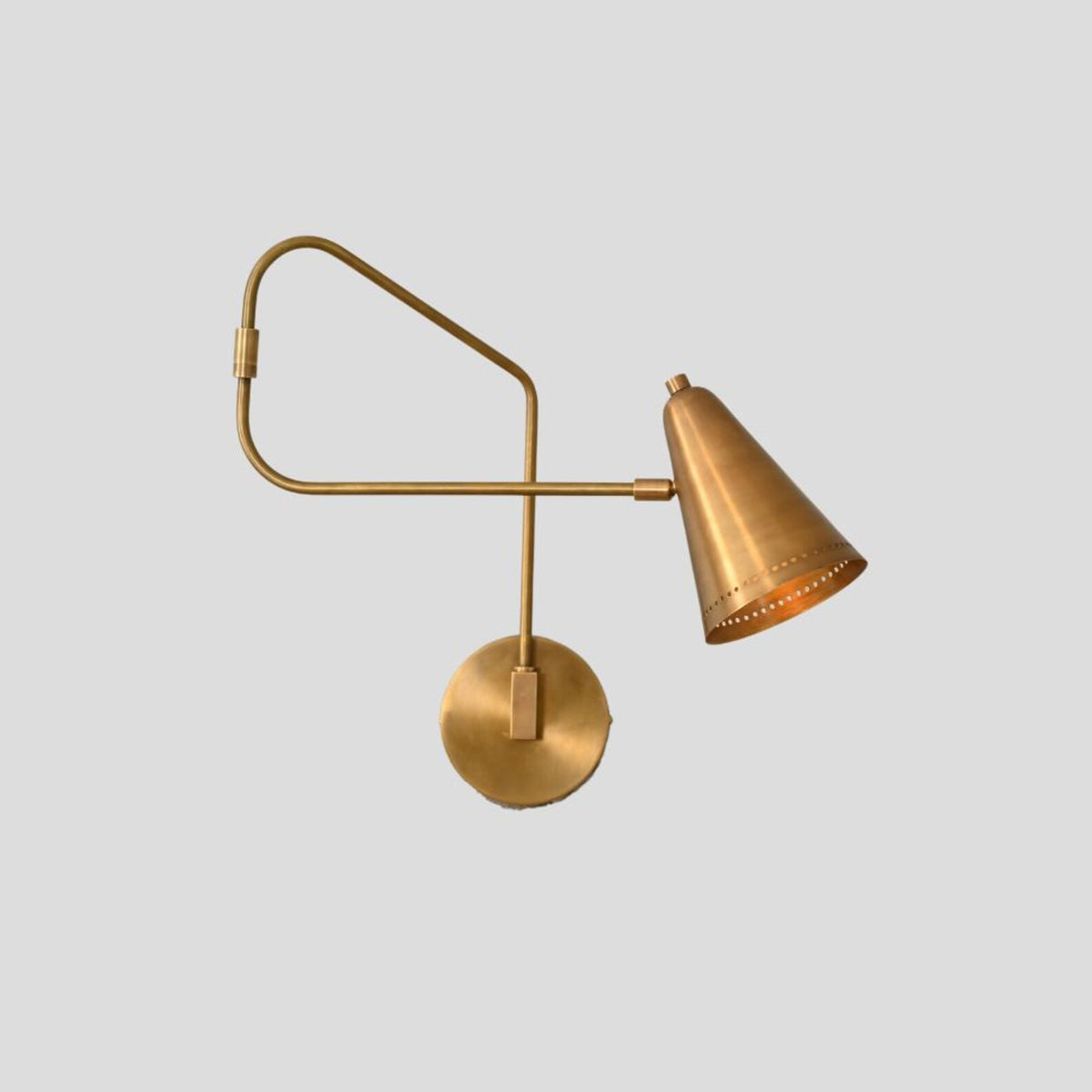 Brass adjustable wall light with swing arm and cone shade, industrial modern style side angle