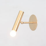 Minimalist brass adjustable spotlight with cylindrical shape and swivel arm for directional lighting