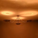 Warm ceiling reflections created by polished chrome brass bowl ceiling light with indirect lighting design.