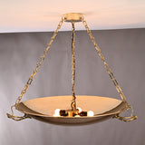 Close-up of brass bowl chandelier showing 5-light configuration and polished reflective surface